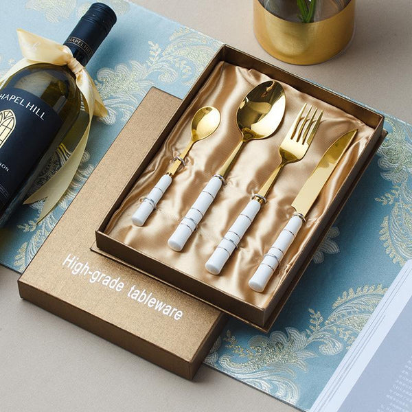 4 Piece Gold and White Flatware Set with Ceramic Handle